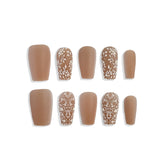 Set of brown nail extensions with floral patterns on a white background
