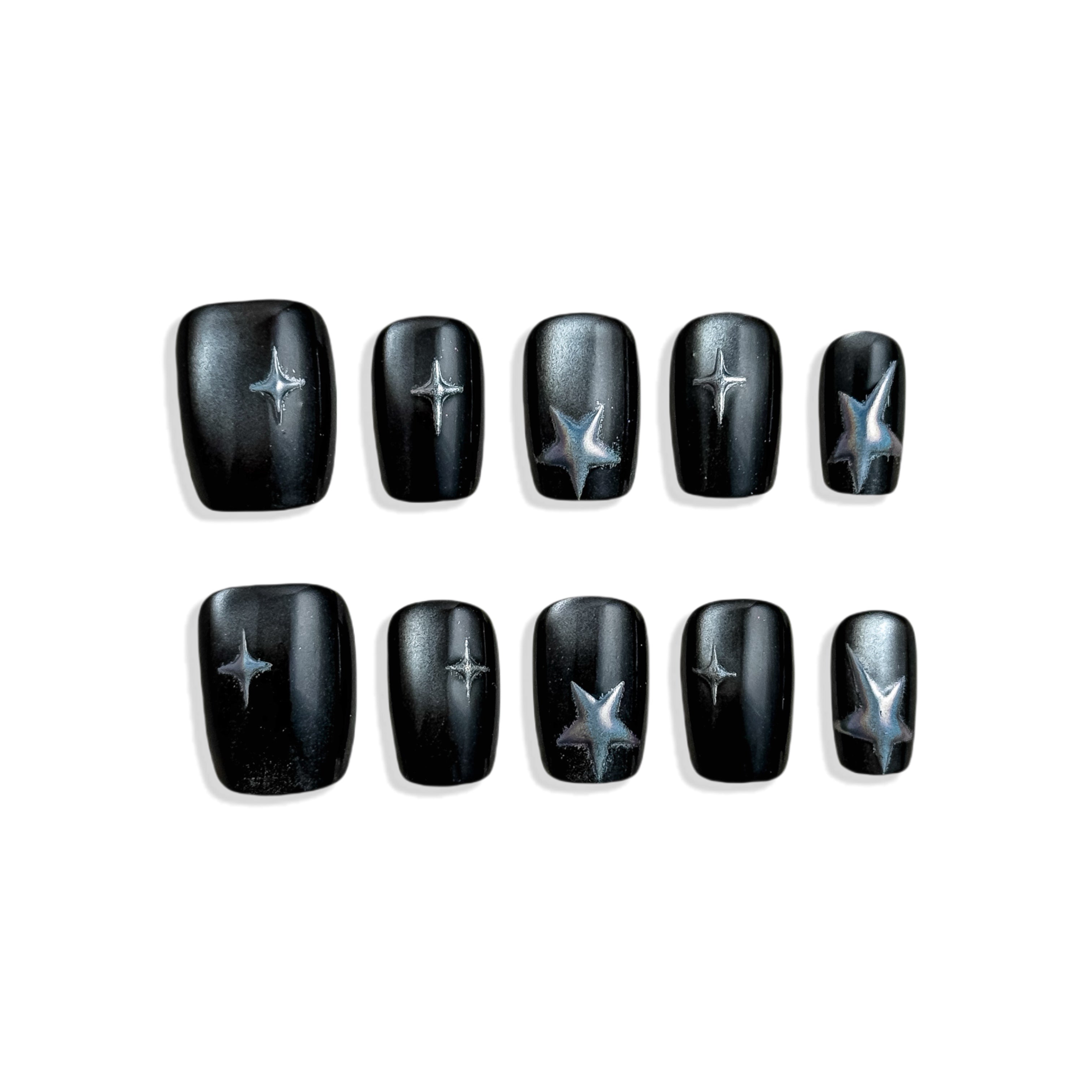 Black nail wraps with star designs on a white background