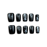 Black nail wraps with star designs on a white background