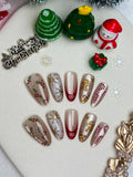 Christmas-themed nail art designs on a white surface with decorative items.