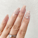 Hand with decorative nail art on a light background